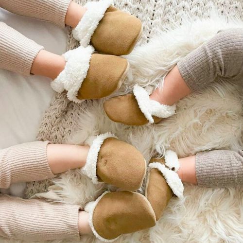 Three young children wearing Dotty Fish tan slippers.