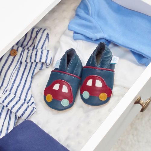 Navy leather shoes with car design, in drawer with baby clothes.