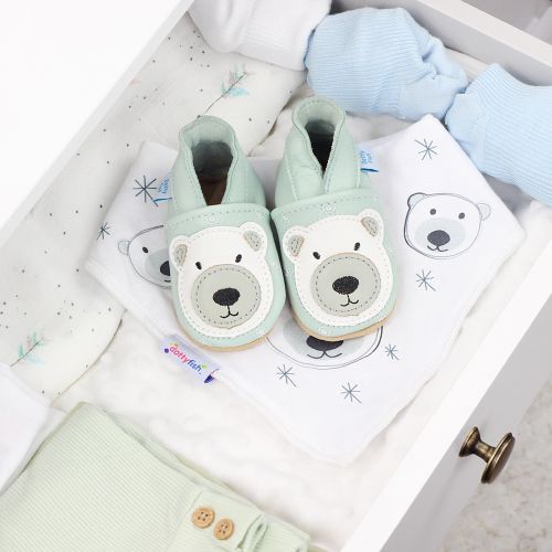 Leather polar bear shoes, in drawer with baby clothing.