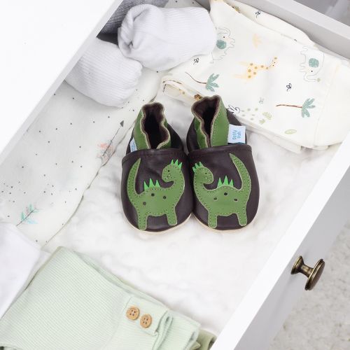 Leather dinosaur shoes with baby blankets.