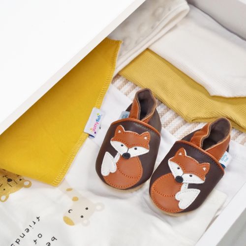 Leather baby shoes with fox design, in drawer with baby clothing.