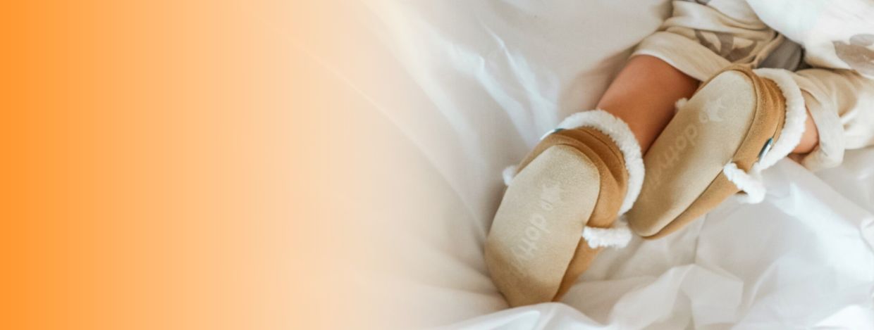 Boy wearing Dotty Fish tan suede slippers