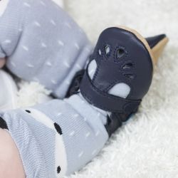 Toddler wearing navy leather Dotty Fish baby and toddler girl’s soft sole T-bar shoes.