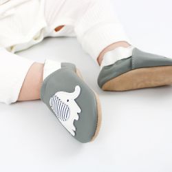 Toddler wearing grey leather Dotty Fish first walker shoes with white and grey stripe elephant design.