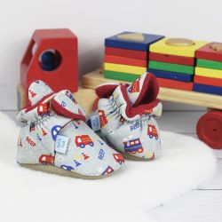 Grey cotton Dotty Fish baby soft sole booties with red fleece lining and vehicle pattern, sitting with wooden toys.