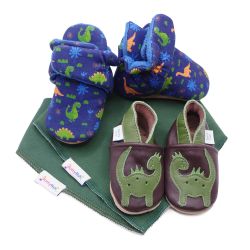 Dotty Fish baby gift set including cotton dinosaur booties, leather dinosaur shoes and two dark green cotton bibs.