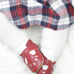 Toddler wearing red leather Dotty Fish baby and toddler girl’s soft sole T-bar shoes.